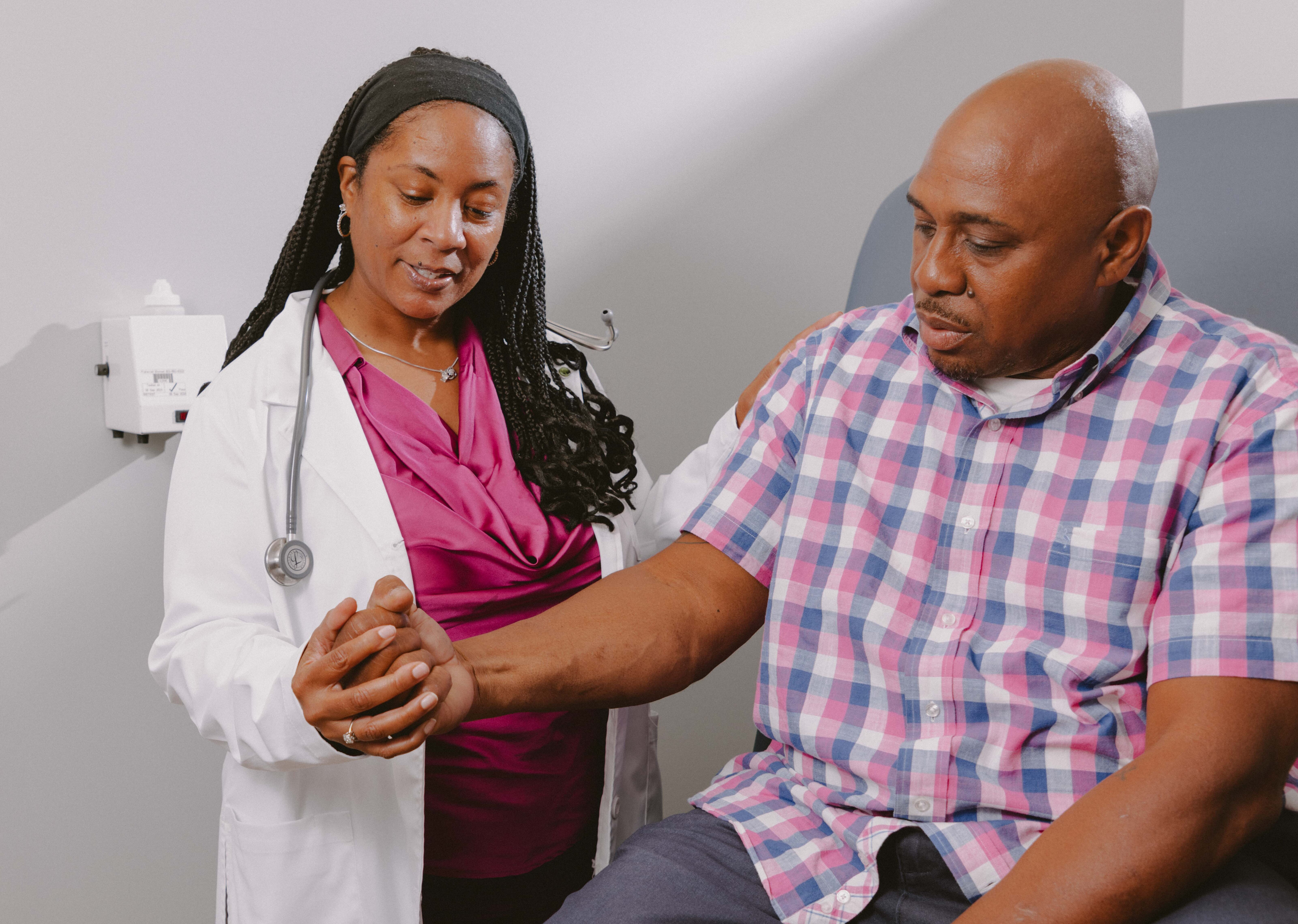 Adelante Healthcare provider examining her male patient